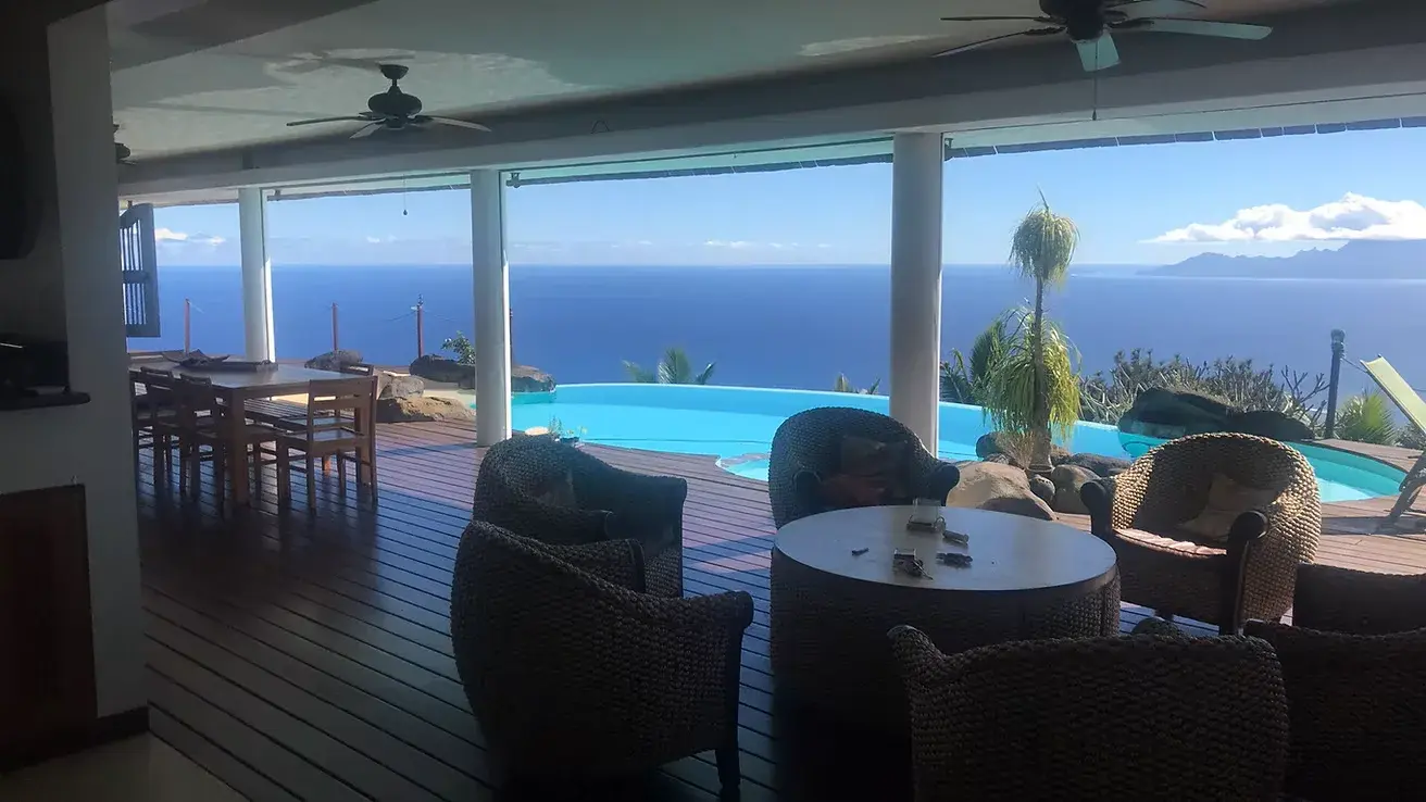 Outdoor deck with loungers and tropical garden